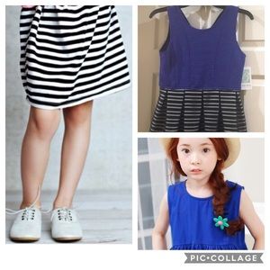 Little girl's sleeveless blue and black dress.